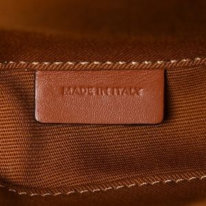 This is an authentic CELINE Triomphe Canvas Triangle Crossbody Bag in Tan.